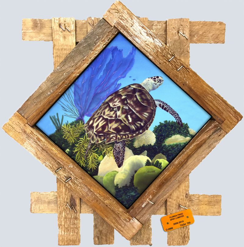 painting of a turtle on a reef printed on a ceramic tile and placed in a diamond shaped lobster trap lid frame